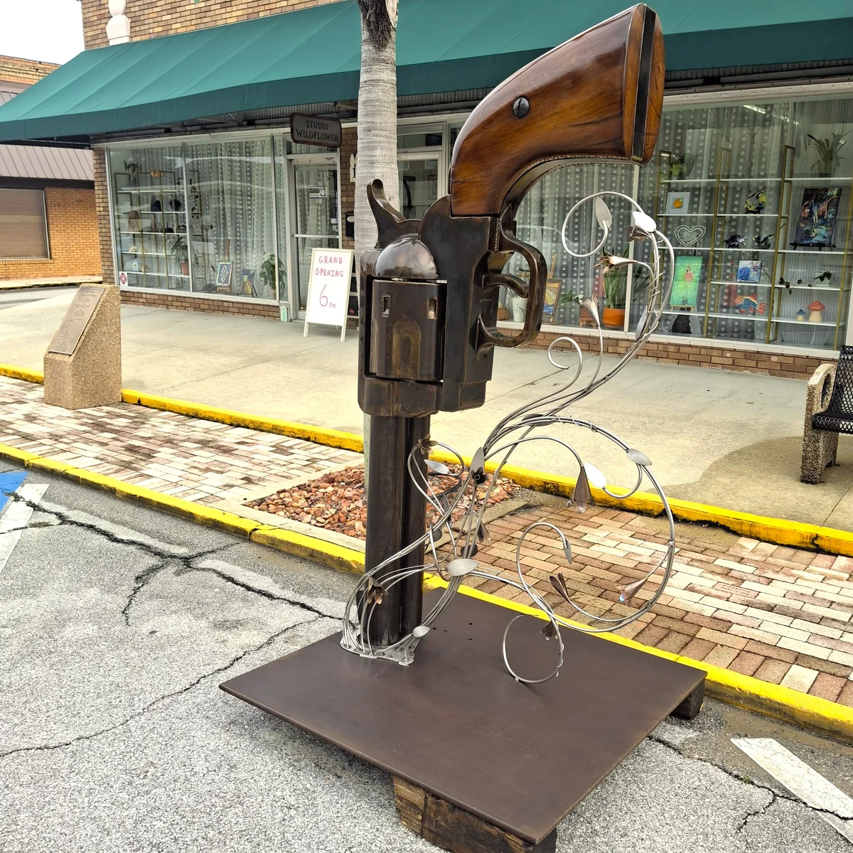 Full sculpture displayed outdoors in front of a storefront.