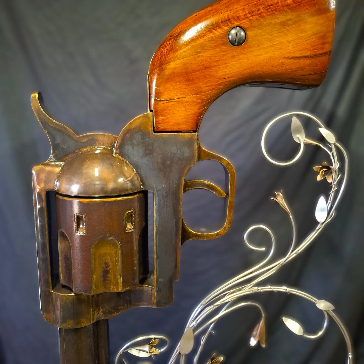 Close view of the revolver's cylinder, trigger guard, and white oak grip.