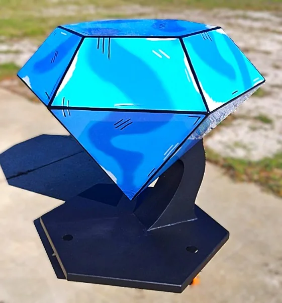 Close view of the blue faceted sculpture and its black pedestal base.