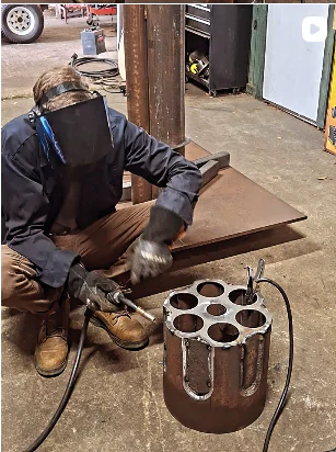 Enlarged revolver cylinder being fabricated in the workshop.
