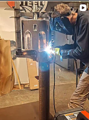 Welding the upright revolver structure during fabrication.