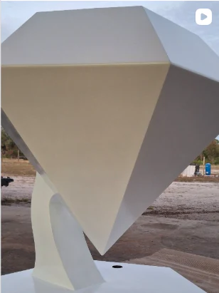 Diamond sculpture in a light neutral painted finish.