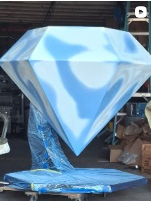 Diamond sculpture in a reflective light-blue finish.